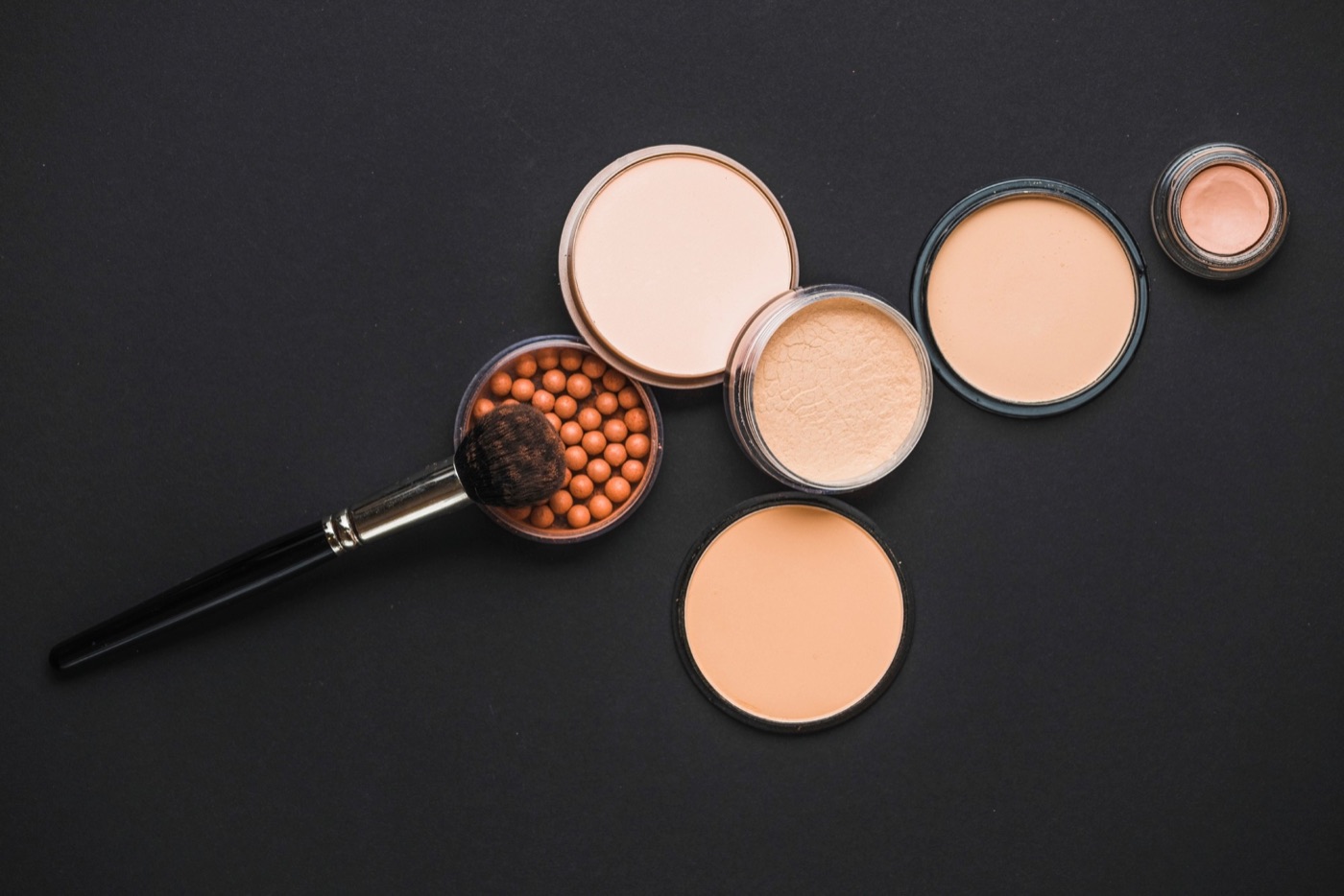 Powders and a makeup brush